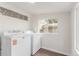 Functional laundry room with modern washer and dryer, bright windows, and ample space at 3501 W 53Rd Ave, Denver, CO 80221