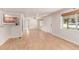 Bright and airy living room featuring hardwood floors, white walls, and a view of the kitchen area at 3501 W 53Rd Ave, Denver, CO 80221