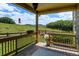 Relaxing back porch with great views of the mountains and a cozy outdoor seating area and lovely plants at 2815 Dreamcatcher Loop, Castle Rock, CO 80109