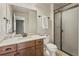 Bathroom featuring a vanity with a quartz countertop, framed mirror, and glass-enclosed shower at 2815 Dreamcatcher Loop, Castle Rock, CO 80109
