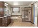 Bathroom featuring dual sink vanity, soaking tub, and separate shower with bench at 2815 Dreamcatcher Loop, Castle Rock, CO 80109