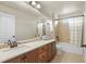 Bathroom with vanity, large mirror, and a shower-tub combination with a neutral palette at 2815 Dreamcatcher Loop, Castle Rock, CO 80109