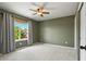 Cozy bedroom featuring a ceiling fan, neutral paint, and a window providing natural light at 2815 Dreamcatcher Loop, Castle Rock, CO 80109