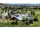 Aerial view of a luxurious community pool area, with multiple pools, seating, and recreational amenities for residents at 2815 Dreamcatcher Loop, Castle Rock, CO 80109