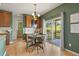 Dining area with a wooden table, chandelier, and a sliding glass door to the outdoor patio at 2815 Dreamcatcher Loop, Castle Rock, CO 80109