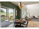Dining area with outdoor views from the patio, wood floors, and a chandelier at 2815 Dreamcatcher Loop, Castle Rock, CO 80109