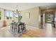 Elegant dining area featuring a modern table set for six, hardwood floors, and a scenic view, perfect for entertaining at 2815 Dreamcatcher Loop, Castle Rock, CO 80109