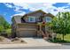Charming two-story house with a two-car garage, stone accents, and a lovely front porch, creating a welcoming curb appeal at 2815 Dreamcatcher Loop, Castle Rock, CO 80109