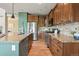 Kitchen with stainless steel appliances, granite countertops, wooden cabinets, and a central island at 2815 Dreamcatcher Loop, Castle Rock, CO 80109