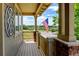 Inviting front porch with wood flooring, brick columns, and an American flag, offering a cozy outdoor space at 2815 Dreamcatcher Loop, Castle Rock, CO 80109