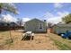 Exterior shot of the home backyard with grass and a storage shed at 7221 E 66Th Pl, Commerce City, CO 80022