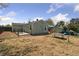 Spacious backyard with green house, patio seating, shed, and picnic table at 7221 E 66Th Pl, Commerce City, CO 80022