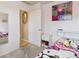 View of a bedroom with a doorway to an en-suite bathroom at 7221 E 66Th Pl, Commerce City, CO 80022