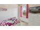 bedroom has pink accents, a window, TV and a white dresser at 7221 E 66Th Pl, Commerce City, CO 80022