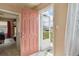 Inviting entryway featuring a charming pink door and a glimpse into the home's interior at 7221 E 66Th Pl, Commerce City, CO 80022