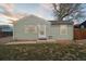 Charming home with a well-maintained lawn and complemented by the trees and blue skies above at 7221 E 66Th Pl, Commerce City, CO 80022