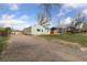 Charming home with a gravel drive and fenced front yard at 7221 E 66Th Pl, Commerce City, CO 80022