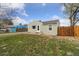 Cozy home with green lawn and tidy landscaping, set against a bright, sunny sky at 7221 E 66Th Pl, Commerce City, CO 80022