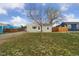 Charming home with a green lawn, complemented by a lovely tree at 7221 E 66Th Pl, Commerce City, CO 80022