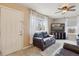 Comfortable living room with a leather sofa, ceiling fan, and natural light at 7221 E 66Th Pl, Commerce City, CO 80022