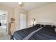 Bedroom features a dark comforter set, a window and white closet at 7221 E 66Th Pl, Commerce City, CO 80022