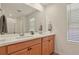 Well-lit primary bath with dual sinks, spacious countertops, and a large mirror at 23920 E 34Th Ave, Aurora, CO 80019