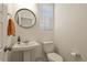 Powder room featuring a pedestal sink, an oval mirror, and a nearby window at 23920 E 34Th Ave, Aurora, CO 80019