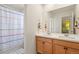 Bright bathroom features a double sink vanity and colorful shower curtain at 23920 E 34Th Ave, Aurora, CO 80019