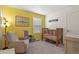 Bright and inviting Bedroom with a crib, chair and calming decor at 23920 E 34Th Ave, Aurora, CO 80019