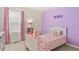 bedroom with lavender wall, butterfly decor, and natural lighting at 23920 E 34Th Ave, Aurora, CO 80019