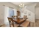 Cozy dining room featuring a rustic wood table with chairs and bench seating at 23920 E 34Th Ave, Aurora, CO 80019