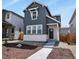 Charming two-story home featuring vertical siding, a stone accent wall, and a well-manicured front yard at 23920 E 34Th Ave, Aurora, CO 80019
