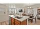 Modern kitchen features stainless steel appliances, white countertops, light wood cabinets, and an island at 23920 E 34Th Ave, Aurora, CO 80019