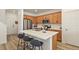 Modern kitchen features stainless steel appliances, a large island with seating, and light wood cabinetry at 23920 E 34Th Ave, Aurora, CO 80019
