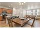 Inviting living space with wood floors, an island with barstool seating, and light-filled dining area at 23920 E 34Th Ave, Aurora, CO 80019