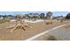 Community playground and sitting area surrounded by mulched area and neighborhood houses in the background at 23920 E 34Th Ave, Aurora, CO 80019