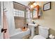 Well-lit bathroom featuring a bathtub, pedestal sink, and tile accents at 1243 S Tejon St, Denver, CO 80223