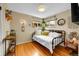 Bright bedroom featuring hardwood floors, cozy daybed, and ample sunlight through multiple windows at 1243 S Tejon St, Denver, CO 80223