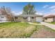 Charming single-story home featuring a well-maintained front yard, inviting entrance, and attached garage at 1243 S Tejon St, Denver, CO 80223