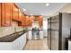 Well-lit kitchen with granite countertops, stainless steel appliances, and plenty of storage at 1243 S Tejon St, Denver, CO 80223
