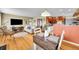 Open-concept living room with hardwood floors connects to the kitchen and dining area at 1243 S Tejon St, Denver, CO 80223