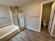 Bathroom with shower/tub combo and updated flooring at 4759 S Flanders St, Centennial, CO 80015