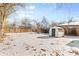 Backyard with shed and snow covered ground at 1570 Xanthia St, Denver, CO 80220