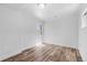 Bright bedroom featuring wood-look floors, a small window, and white brick accent wall at 1570 Xanthia St, Denver, CO 80220