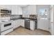 Well-maintained kitchen features white cabinetry, stainless steel appliances, and a tile backsplash at 1570 Xanthia St, Denver, CO 80220