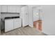 Laundry room with side-by-side washer and dryer and overhead storage cabinets at 1570 Xanthia St, Denver, CO 80220