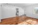 Bright and empty living room with hardwood floors, white walls, and recessed lights at 1570 Xanthia St, Denver, CO 80220