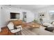 Bright living room boasts hardwood floors, a modern media center, and a cozy seating area at 1570 Xanthia St, Denver, CO 80220