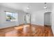 Empty living room featuring hardwood floors, natural light, and freshly painted walls at 1570 Xanthia St, Denver, CO 80220