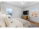 Main bedroom showcases natural light, hardwood floors, and neutral decor at 1570 Xanthia St, Denver, CO 80220
